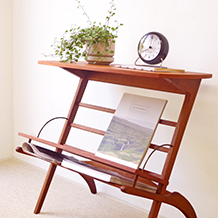 Sculptural coffee table with magazinerack in teak