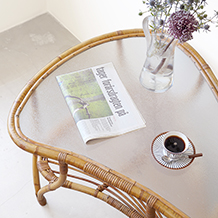 Organic formed coffee table in rattan & glass