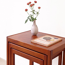 Nesting tables in mahogany and walnut